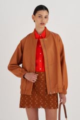 Profile view of model wearing the Oroton Leather Bomber in Tan and 100% Leather for Women