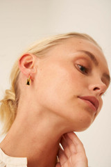 Profile view of model wearing the Oroton Lottie Charm Hoops in Gold and Brass Base With 18CT Gold Plating for Women