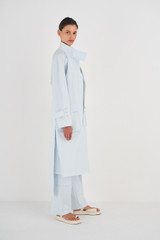 Profile view of model wearing the Oroton Pocket Trench in Sea Glass and 99% Cotton, 1% Spandex for Women