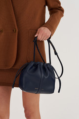 Profile view of model wearing the Oroton Curtis Crossbody in North Sea and Recycled Smooth Leather for Women