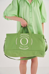Profile view of model wearing the Oroton Kane Weekender in Watercress and Recycled Canvas for Women