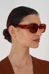 Profile view of model wearing the Oroton Haylen Sunglasses in Amber Tort and Acetate for Women