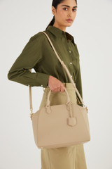Profile view of model wearing the Oroton Inez Day Bag in Fawn and Saffiano Leather for Women