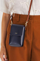 Profile view of model wearing the Oroton Harriet Phone Crossbody in Indigo and Saffiano Leather for Women