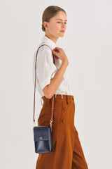 Profile view of model wearing the Oroton Harriet Phone Crossbody in Indigo and Saffiano Leather for Women