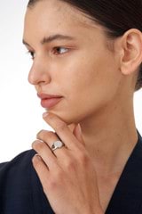 Profile view of model wearing the Oroton Fawne Circle Signet Ring in Silver/Clear and Brass Base With Sterling Silver plating/Cubic Zirconia for Women